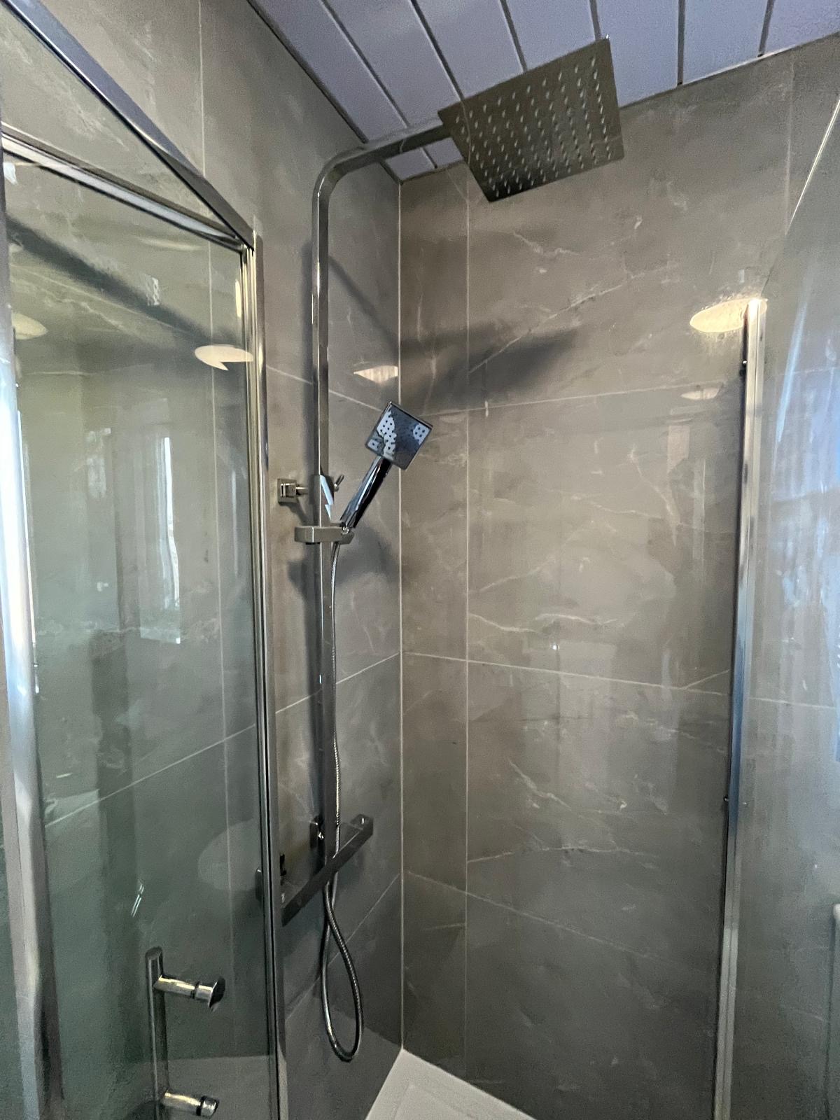 Modern washroom designed with premium marble walls and sleek fittings