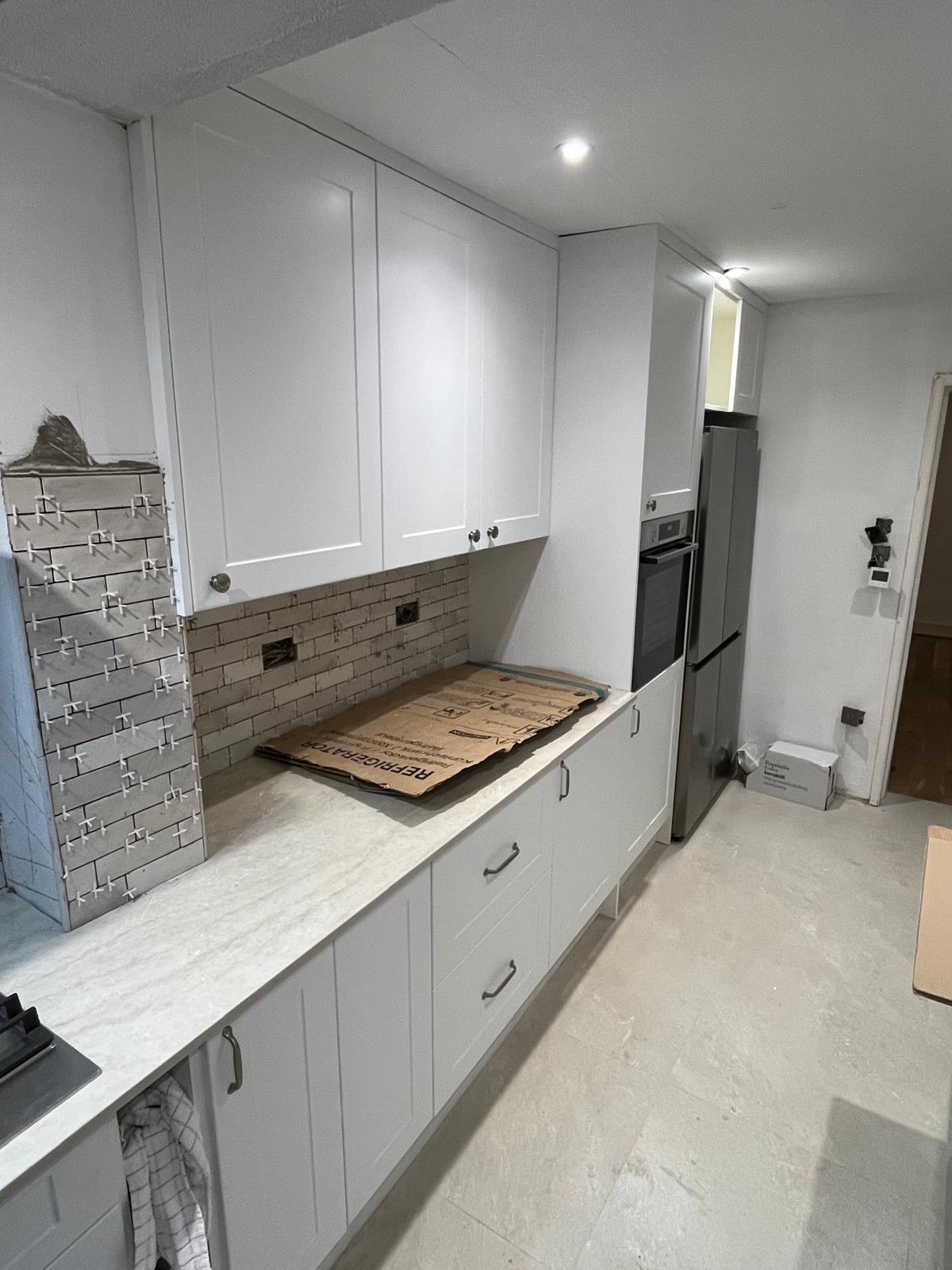 Modular kitchen with cabinets, countertops and wooden flooring