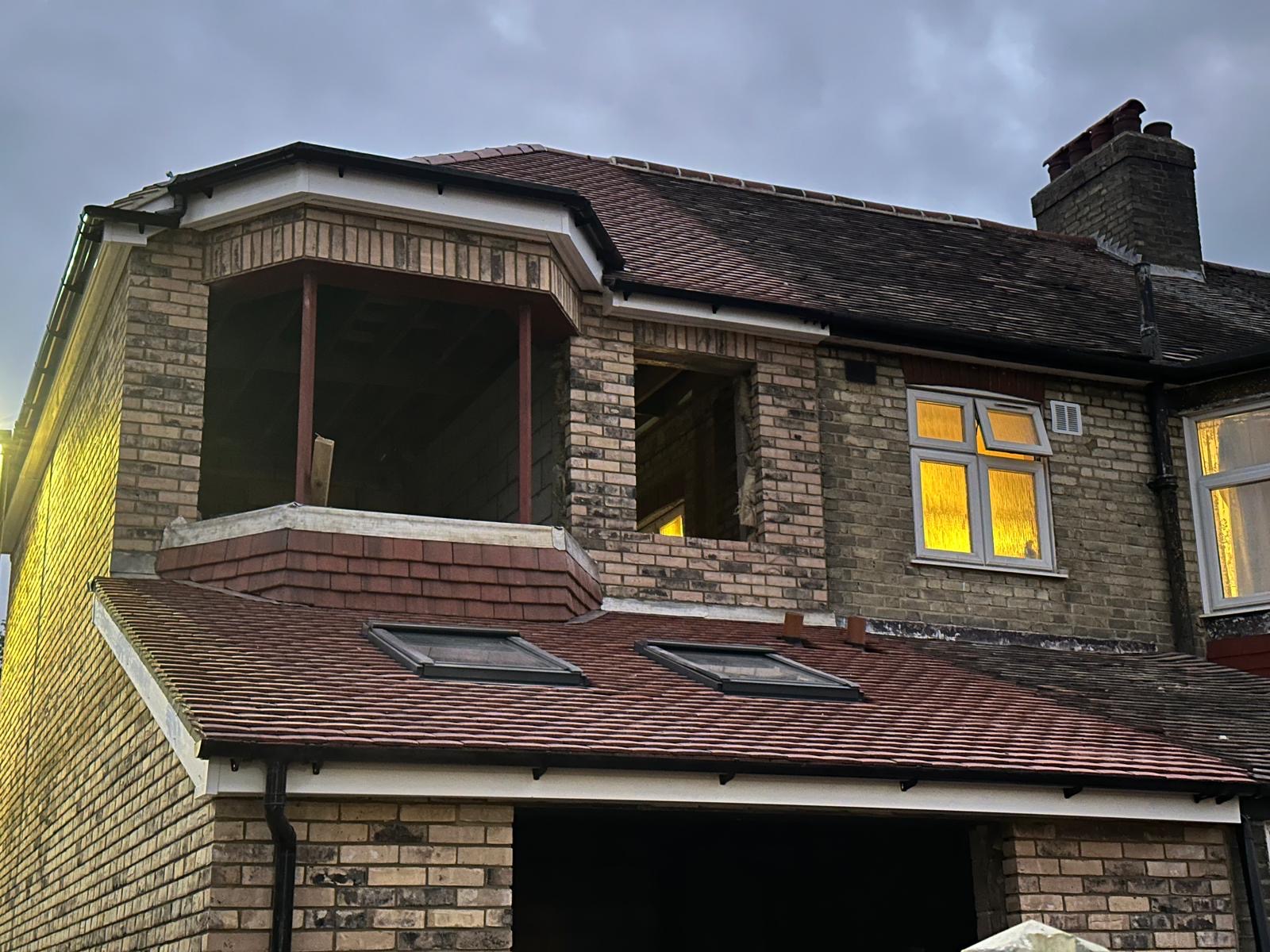 House roof construction with tiles and skylights