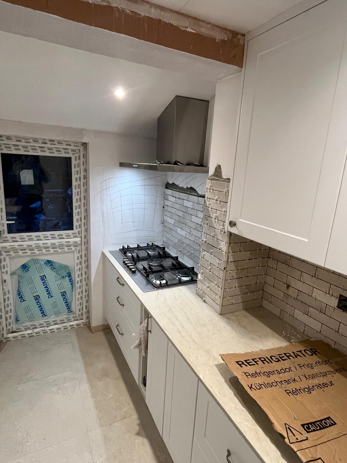 Modular kitchen with cabinets, countertops and wooden flooring