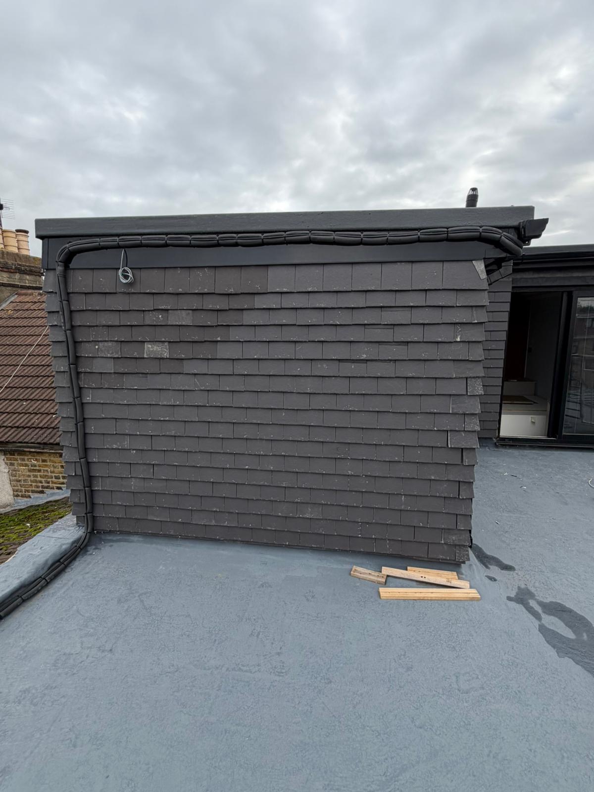 House roof construction with tiles and skylights