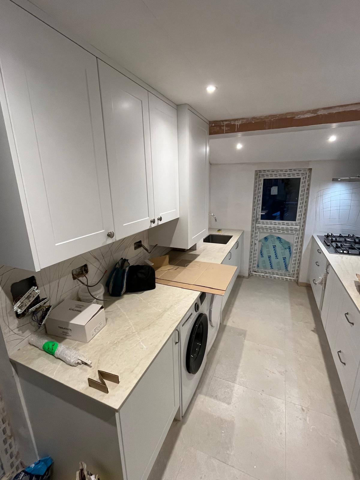 Modular kitchen with cabinets, countertops and wooden flooring