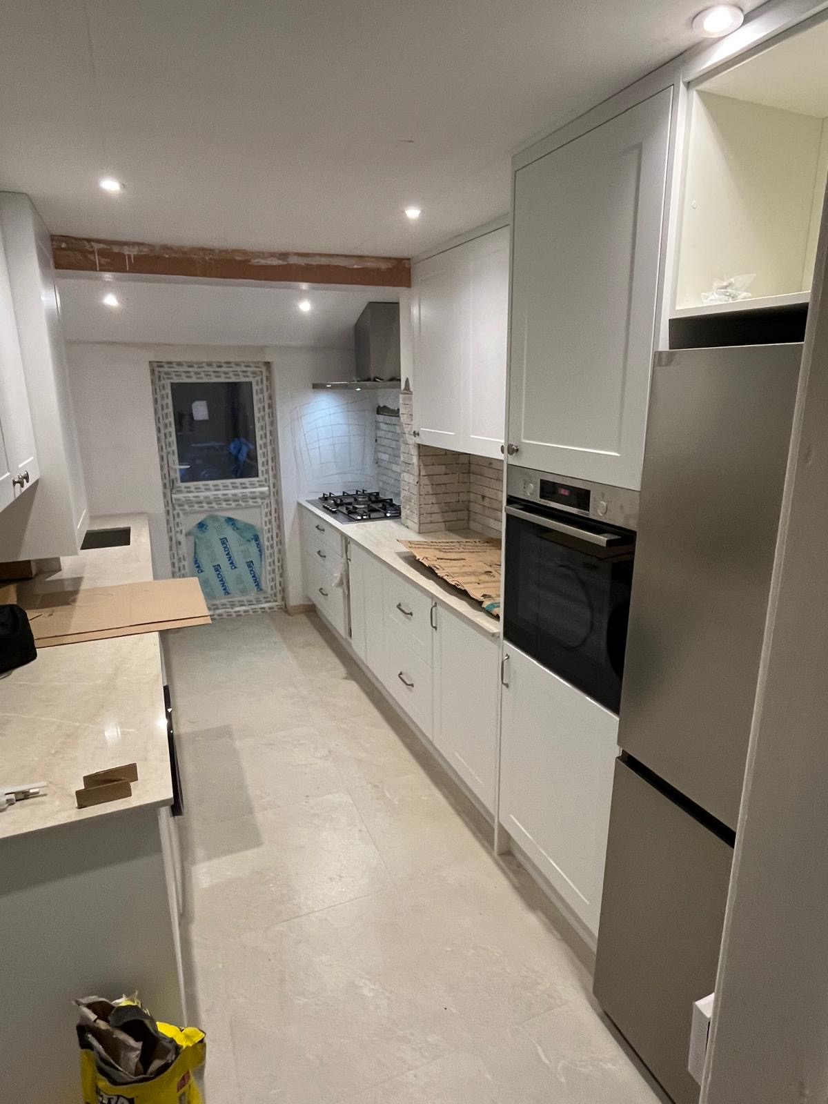Modular kitchen with cabinets, countertops and wooden flooring